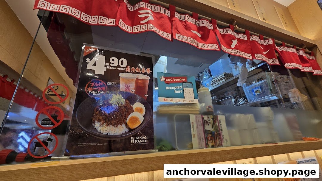 A counter view at Takagi Ramen, featuring a promotional poster for a $4.90 Pulled Pork Value Meal.