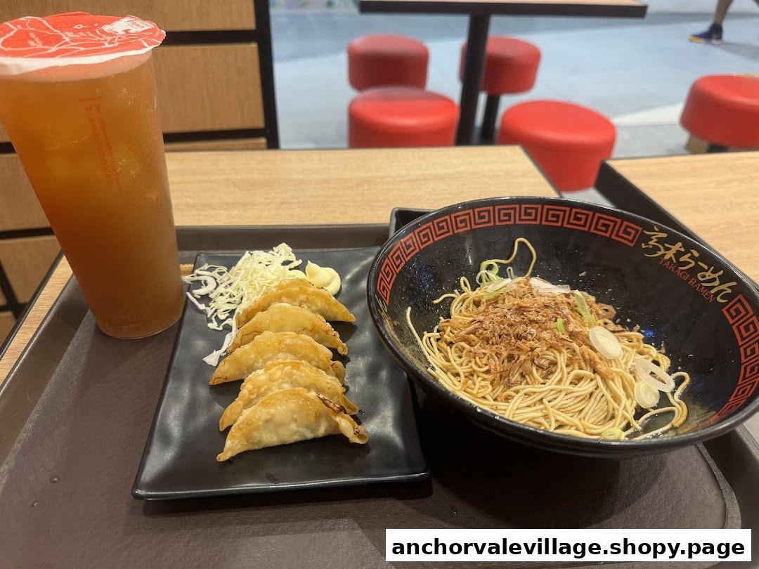 A tray featuring dry ramen, fried gyoza, and an iced drink from Takagi Ramen.