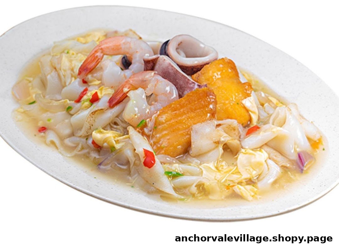 A delicious plate of stir-fried noodles with shrimp, squid, and fish in a savory sauce.