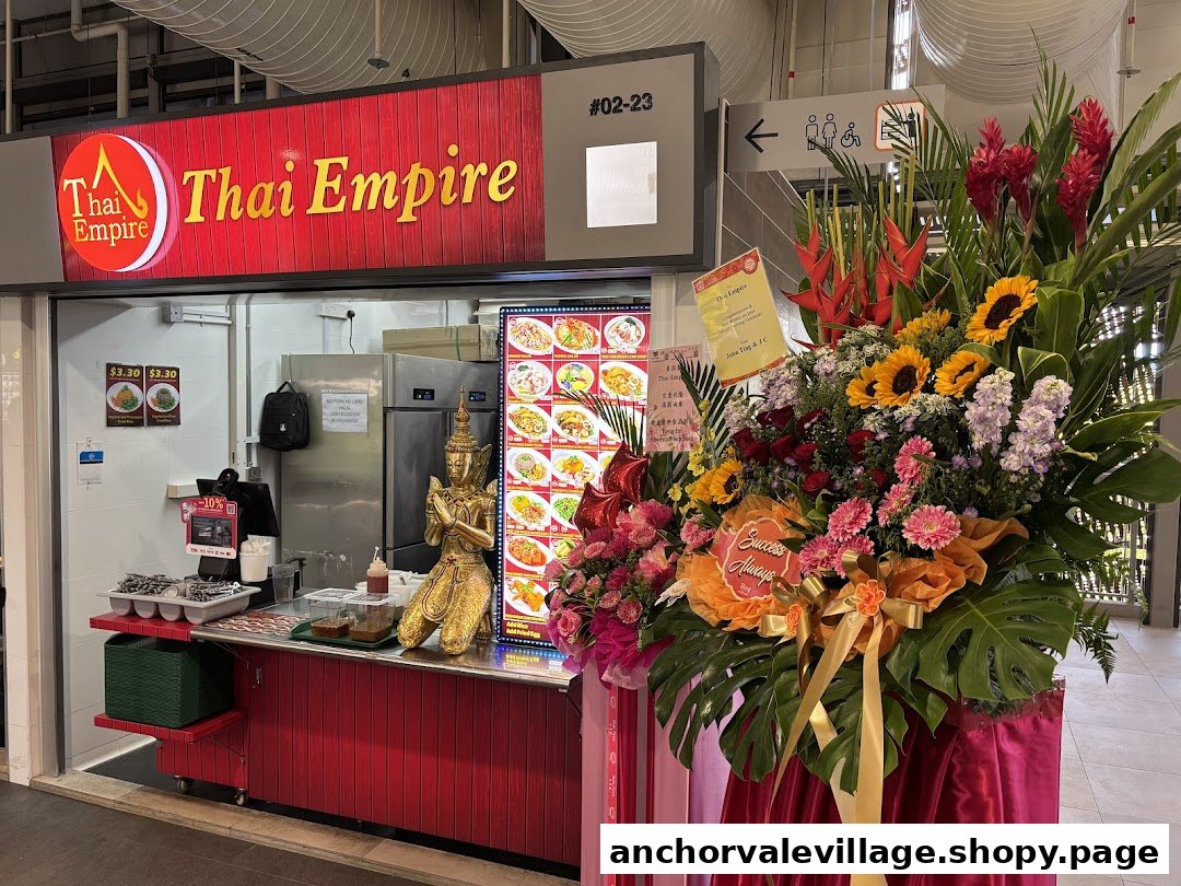 The vibrant red shopfront of Thai Empire, featuring its logo and a large celebratory floral arrangement.