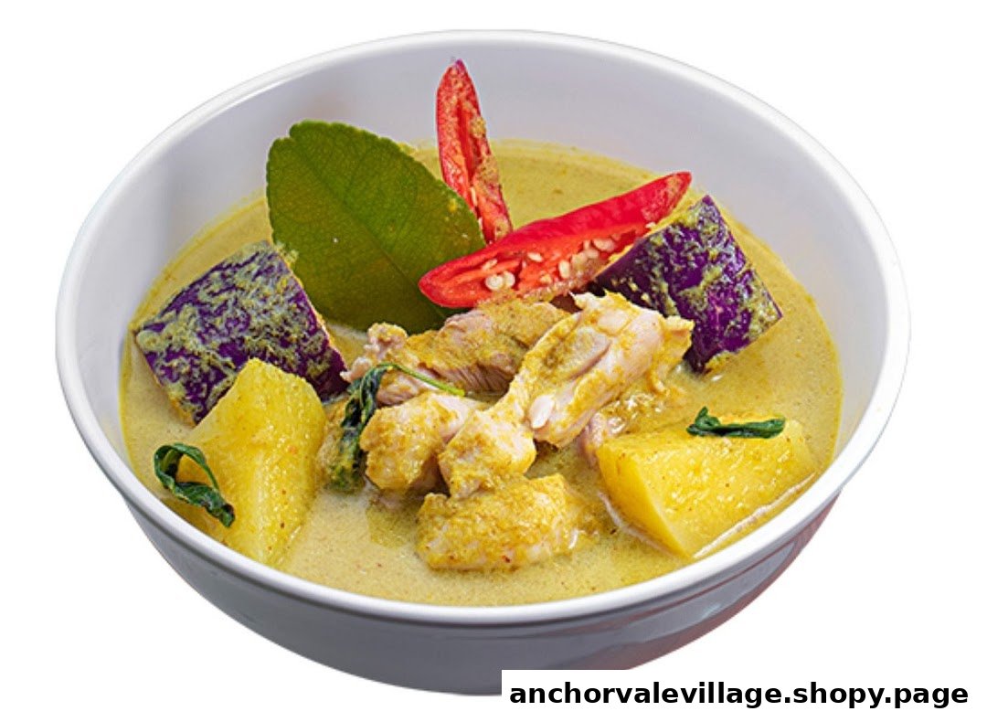 A vibrant bowl of Thai green curry with chicken, vegetables, and fresh garnishes.