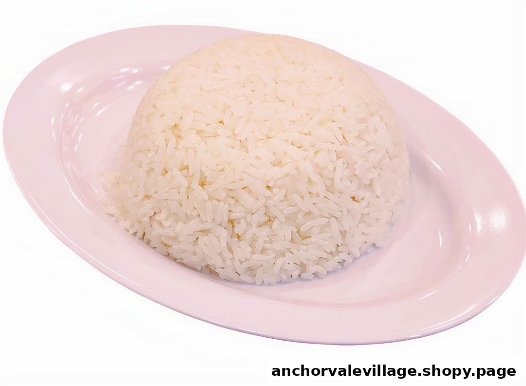 A perfectly cooked mound of white rice served on a pink oval plate.