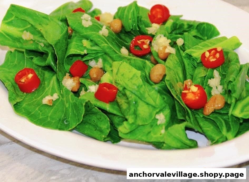 A vibrant dish of green leafy vegetables with red chili slices, peanuts, and minced garlic.