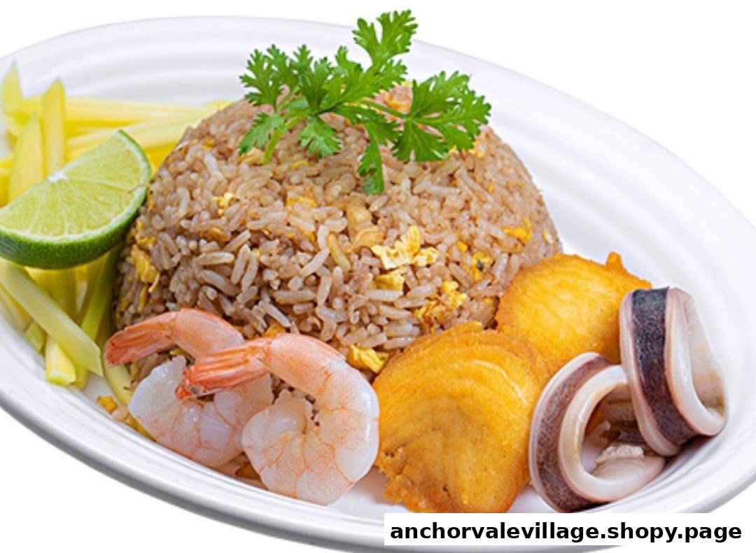 A vibrant plate of Thai fried rice with shrimp, fried fish, squid, lime, and fresh herbs.