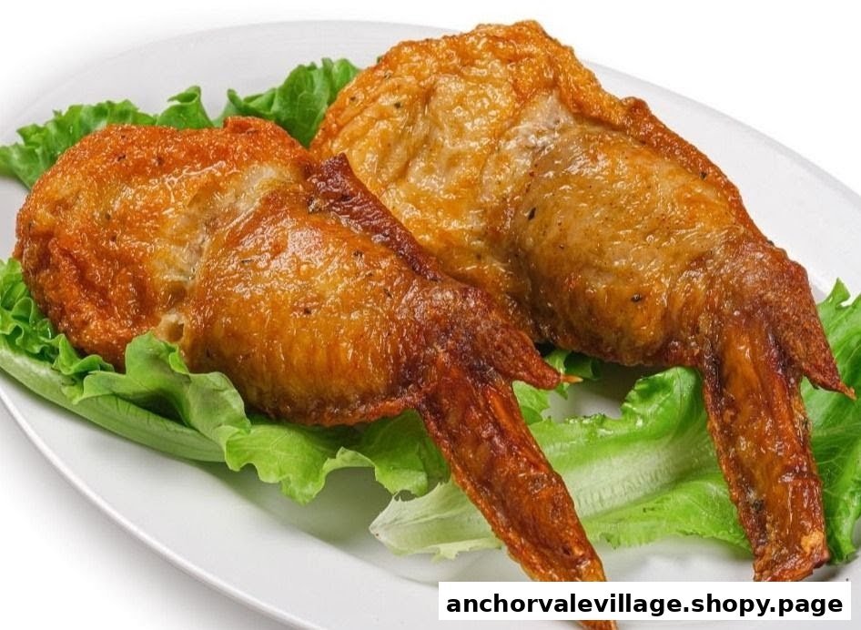 Two golden-brown fried chicken wings served on a bed of fresh green lettuce.