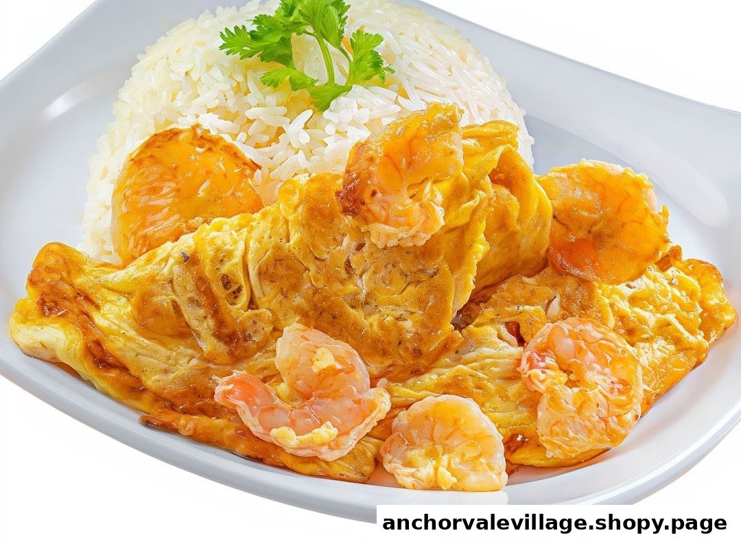 A plate of fluffy white rice served with golden omelet and succulent shrimp, garnished with fresh herbs.