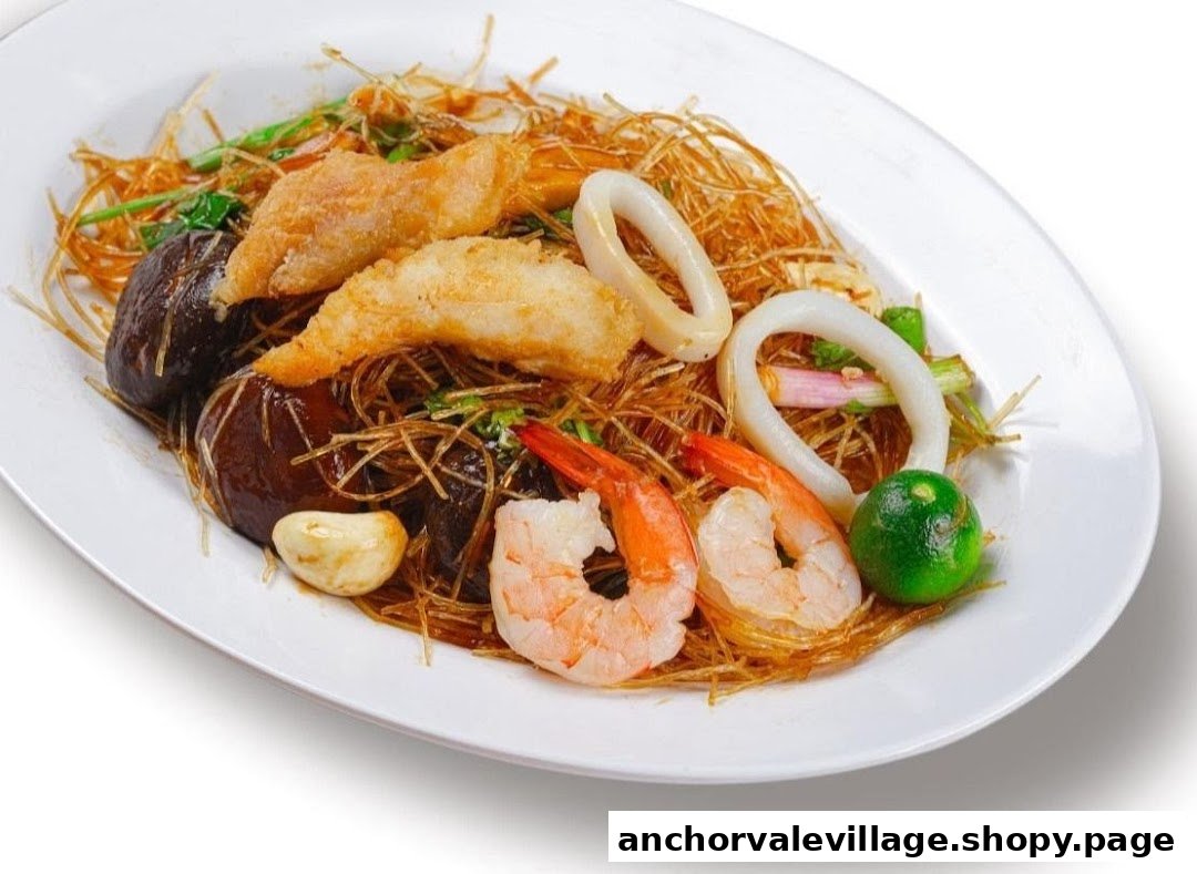 A vibrant Thai noodle dish featuring shrimp, squid, fried fish, mushrooms, and fresh lime.