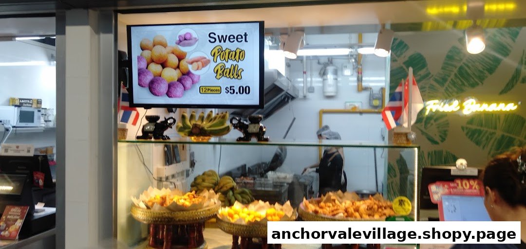 An inviting interior view of Thai Khanom Bananas, showcasing fresh sweet potato balls and other fried snacks.