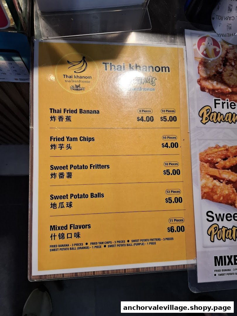 A close-up of the menu board for Thai Khanom Bananas, featuring various fried Thai snacks.