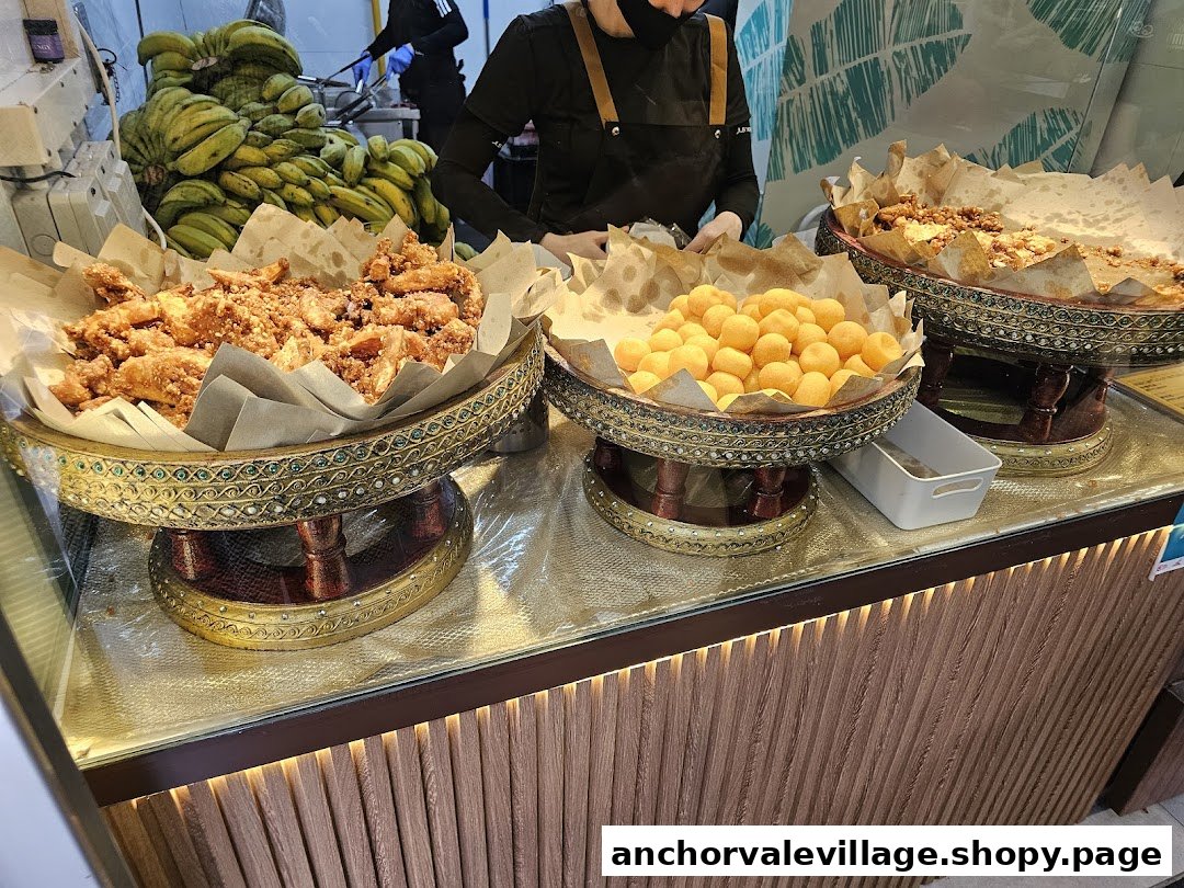 A vibrant display of fried bananas and golden dessert balls at Thai Khanom Bananas.