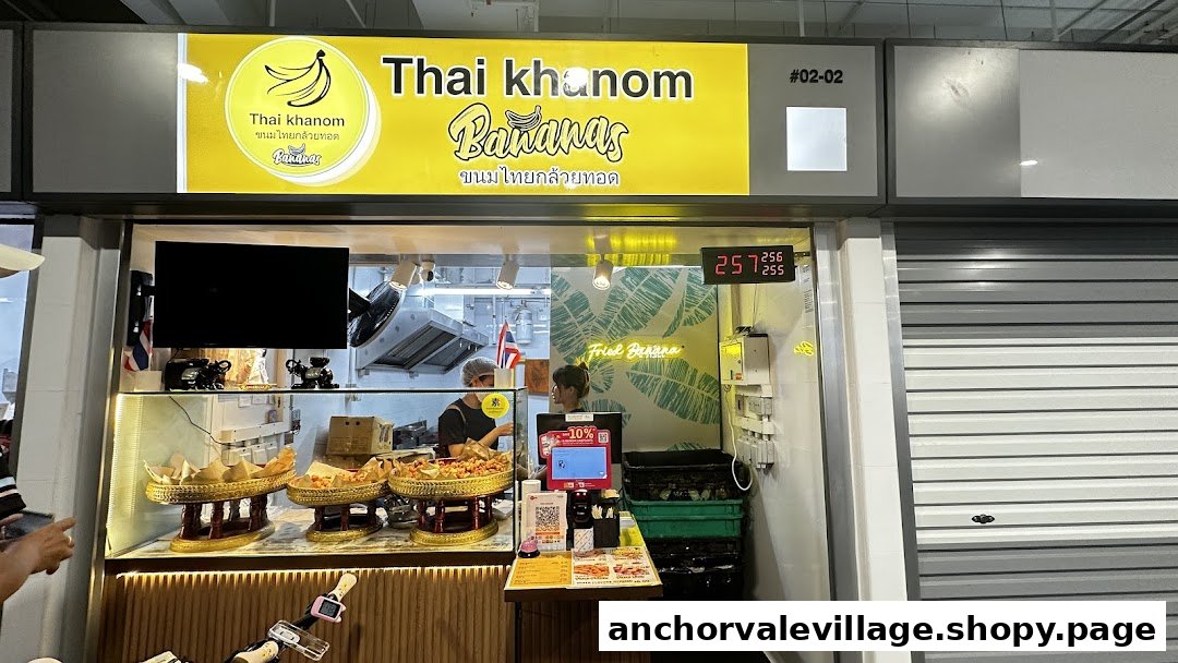 The vibrant storefront of Thai Khanom Bananas, showcasing traditional Thai fried snacks and a busy kitchen.
