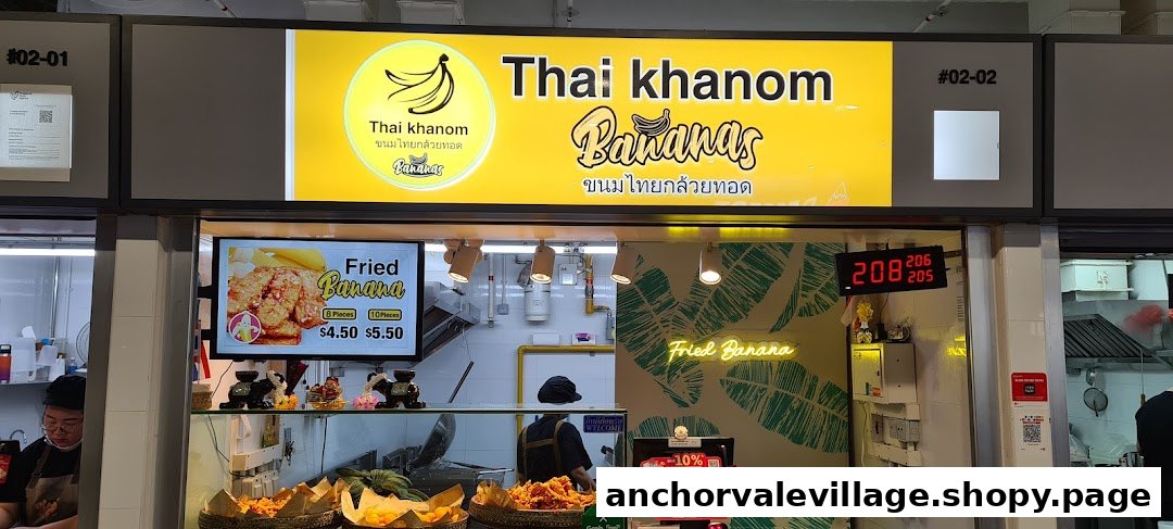 The vibrant yellow storefront of 'Thai Khanom Bananas' showcasing their fried banana offerings.