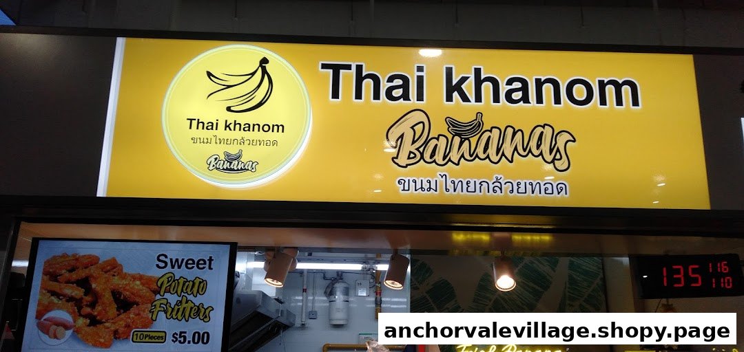 The vibrant sign for Thai Khanom Bananas, featuring a sweet potato fritters menu item.
