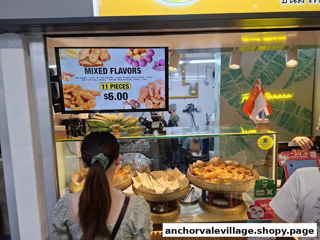 A customer views a digital menu display at Thai Khanom Bananas, showcasing fried snacks.