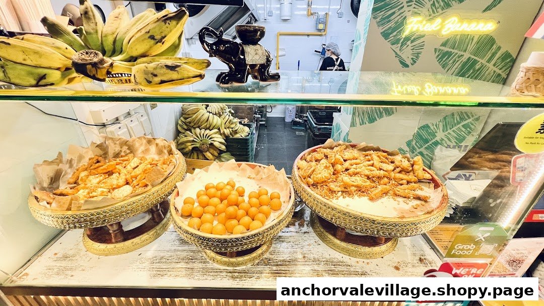 A vibrant display of golden fried bananas and other Thai snacks at Thai Khanom Bananas.