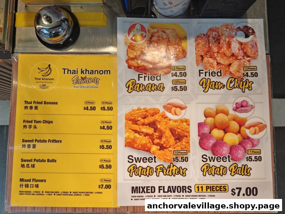 A vibrant menu board showcasing Thai fried bananas, yam chips, and sweet potato snacks with prices.