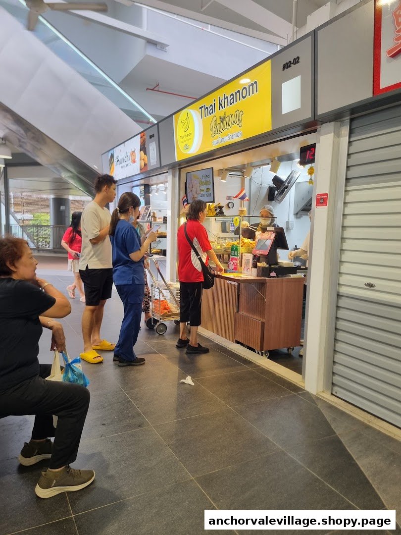 Customers queueing at the counter of the 'Thai Khanom Bananas' food stall.