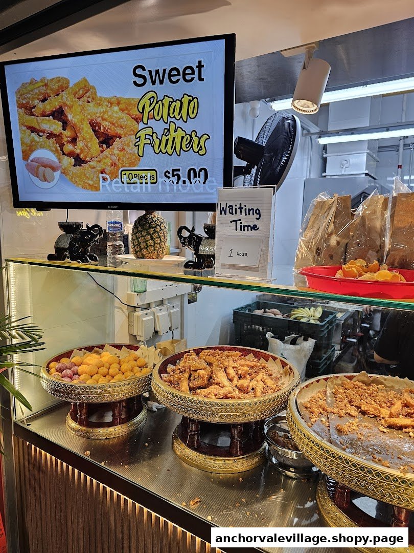 A vibrant display of Thai snacks and a digital menu featuring sweet potato fritters.