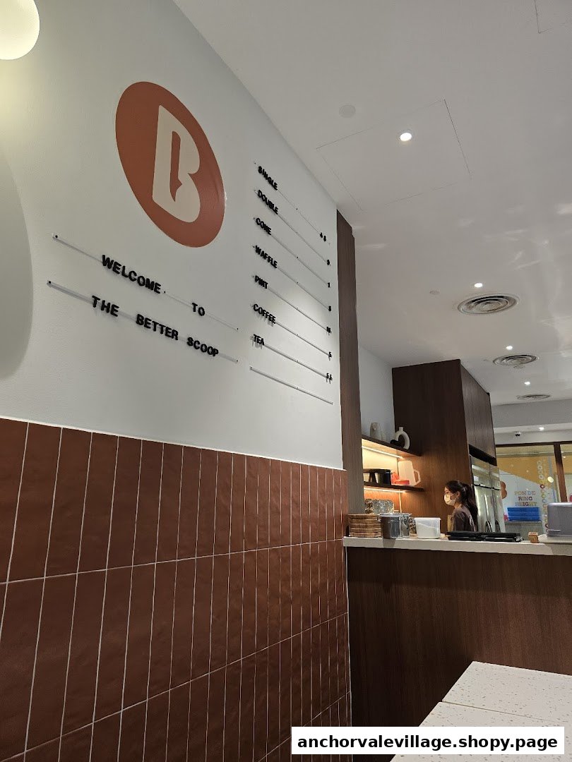 Interior view of The Better Scoop, featuring a counter, staff, and a wall display with menu items.