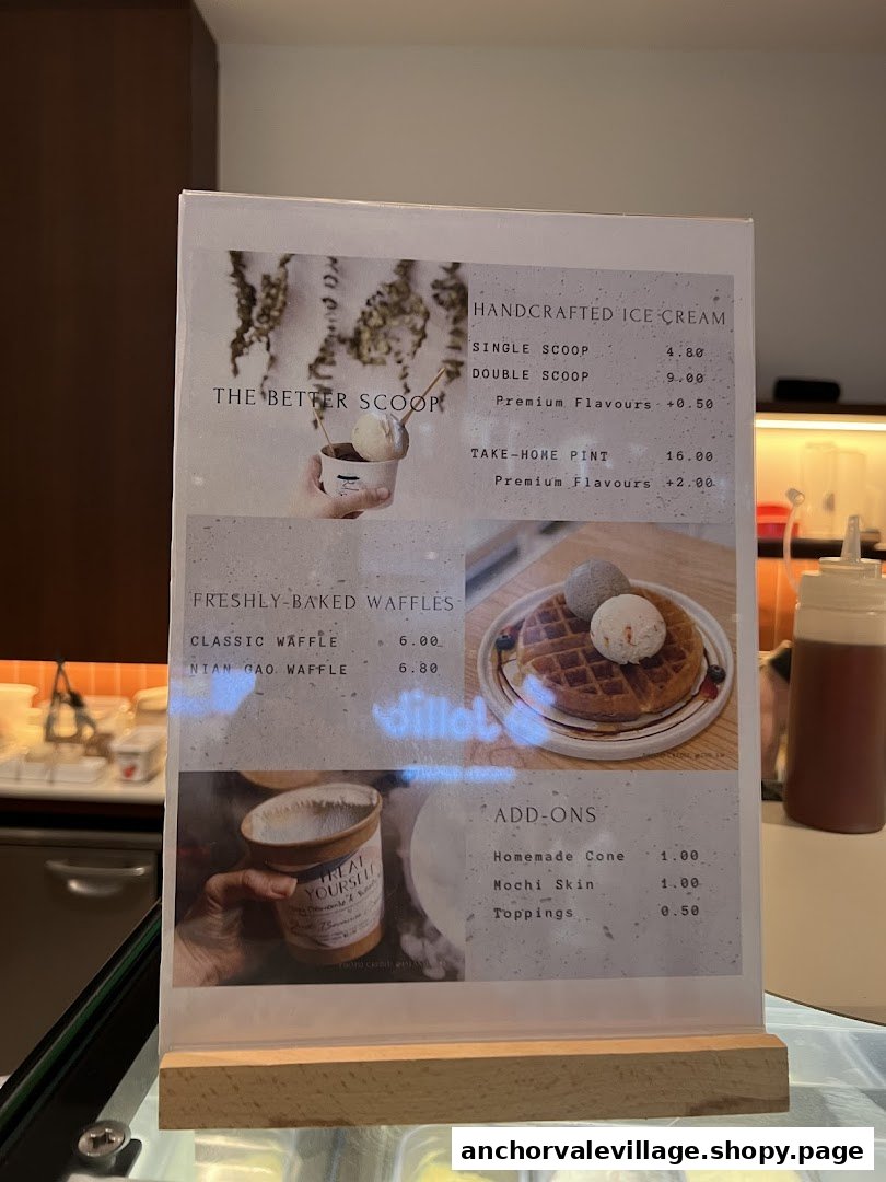 A close-up of The Better Scoop's menu board displaying ice cream, waffles, and add-ons.