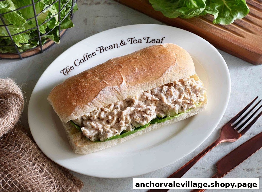A close-up of a savory sandwich on a white plate with The Coffee Bean & Tea Leaf logo.