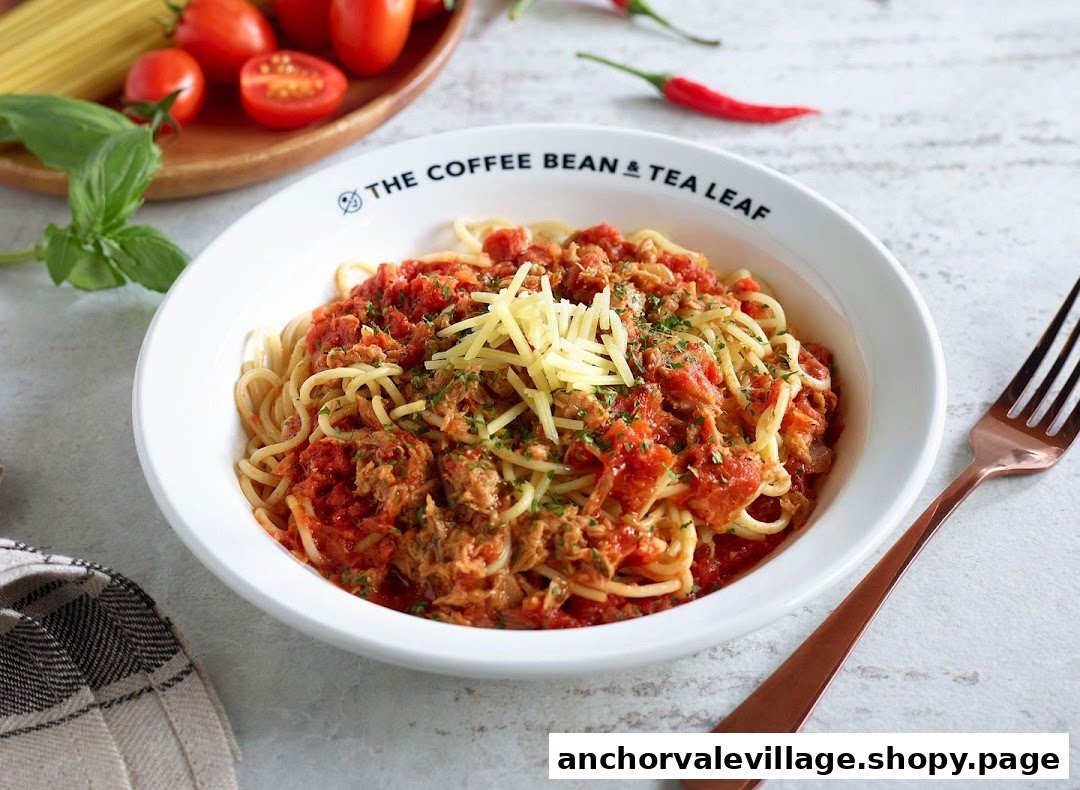 A bowl of spaghetti with tomato sauce, tuna, and shredded cheese from The Coffee Bean & Tea Leaf.