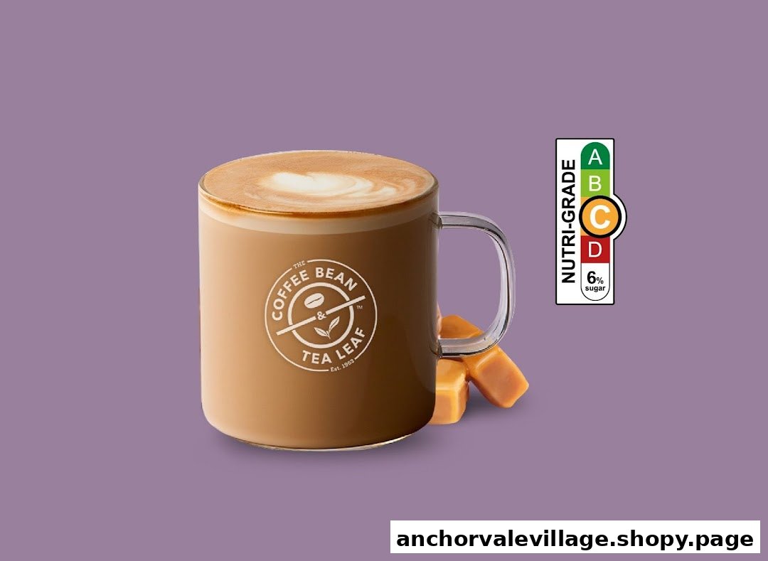 A Coffee Bean & Tea Leaf mug filled with a beverage, accompanied by caramel candies and a nutri-grade label.
