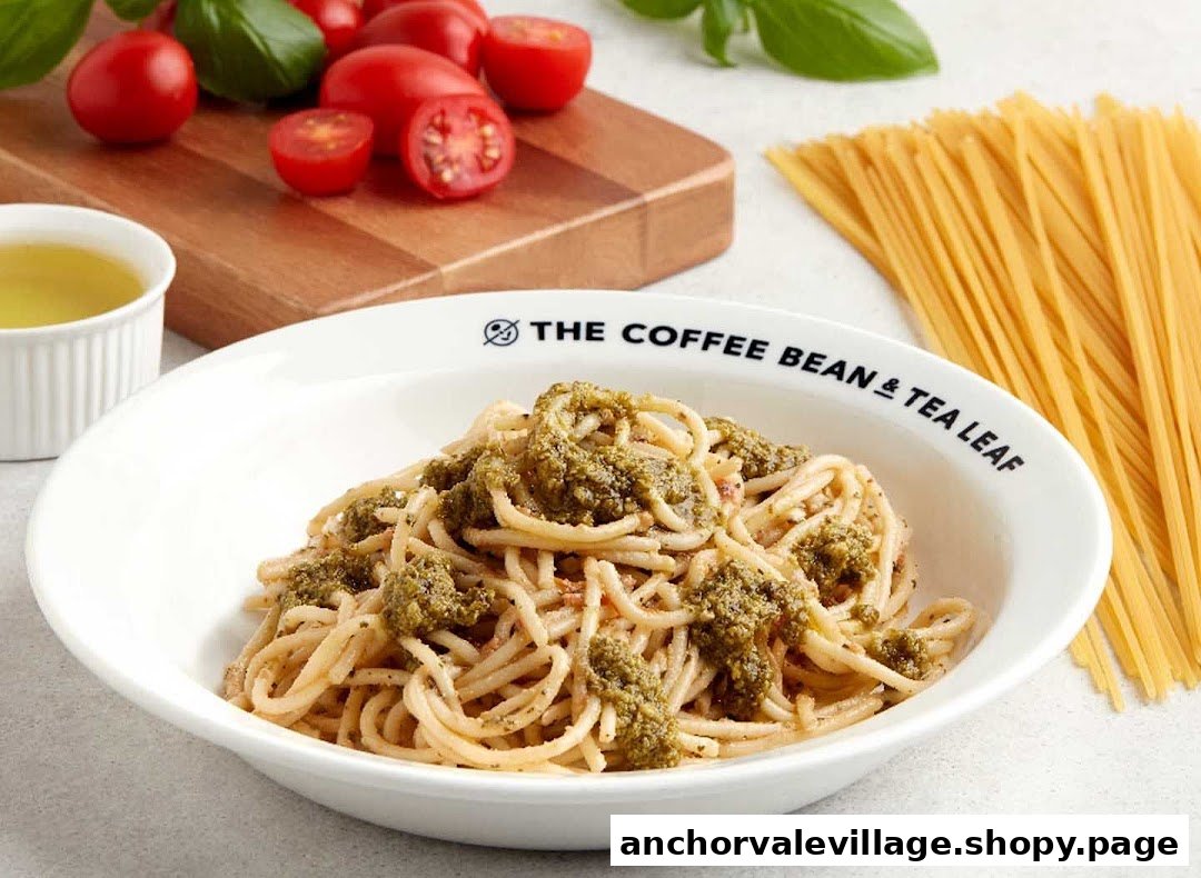 A bowl of pesto spaghetti from The Coffee Bean & Tea Leaf, surrounded by fresh ingredients.