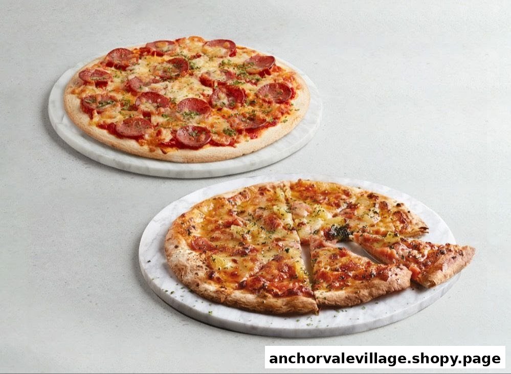 Two delicious pizzas, one pepperoni and one Hawaiian, served on marble platters.