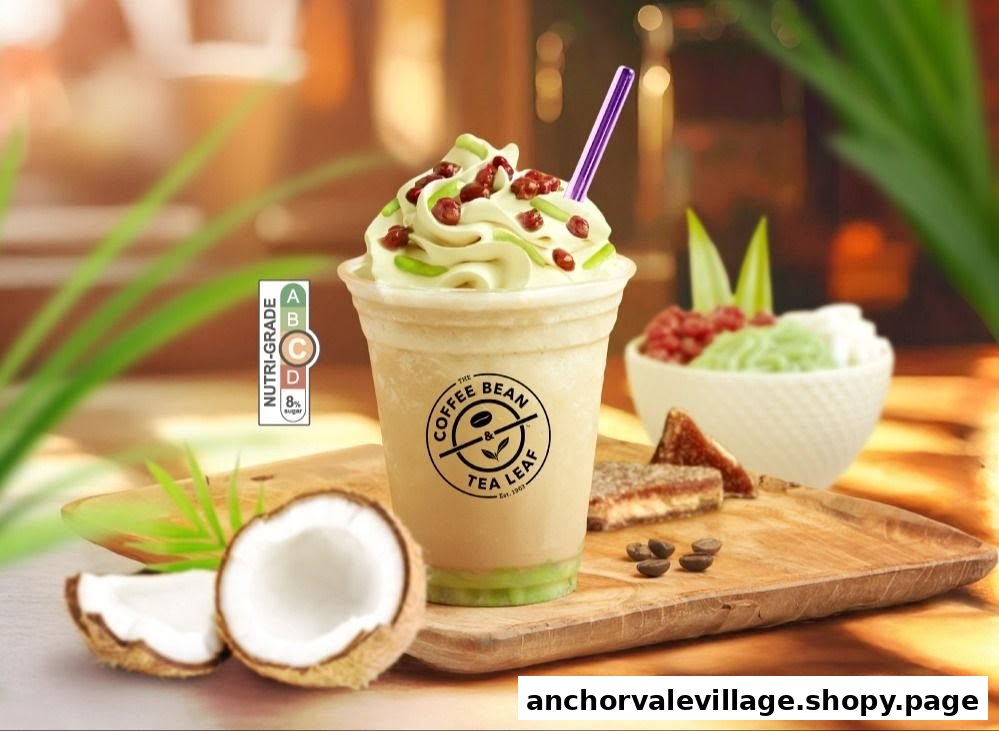 A refreshing blended drink with whipped cream and toppings, alongside coconut and pastries.