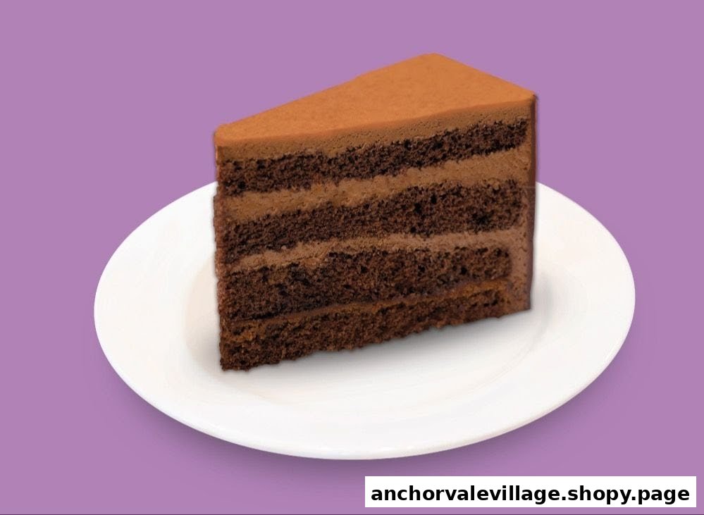 A delicious slice of multi-layered chocolate cake on a white plate.
