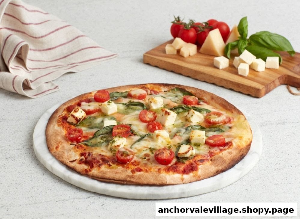 A delicious pizza topped with cherry tomatoes, cheese, and basil, served on a marble board.