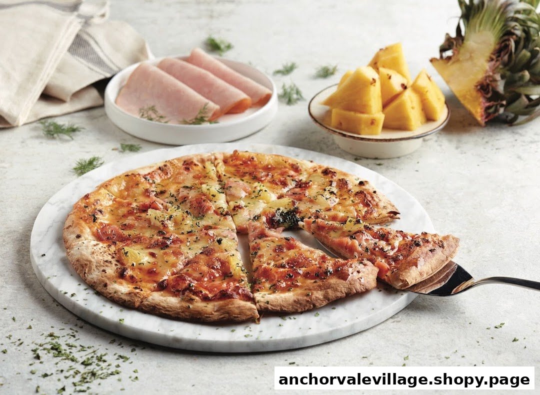 A delicious ham and pineapple pizza on a marble board, with ingredients in the background.