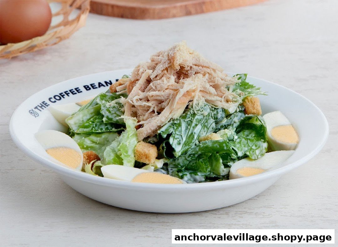 A fresh Caesar salad with shredded chicken, croutons, and hard-boiled eggs.