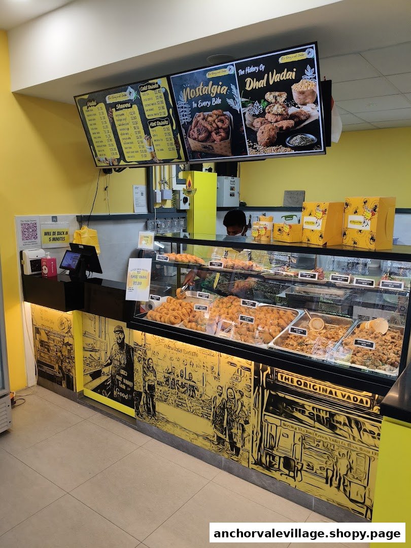 Interior view of The Original Vadai shop featuring a detailed menu board, food display, and counter.