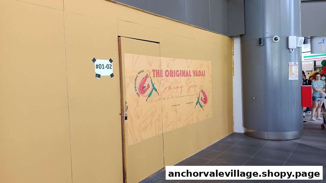 A boarded-up shop front with a 'The Original Vadai Coming Soon' sign, indicating a new opening.