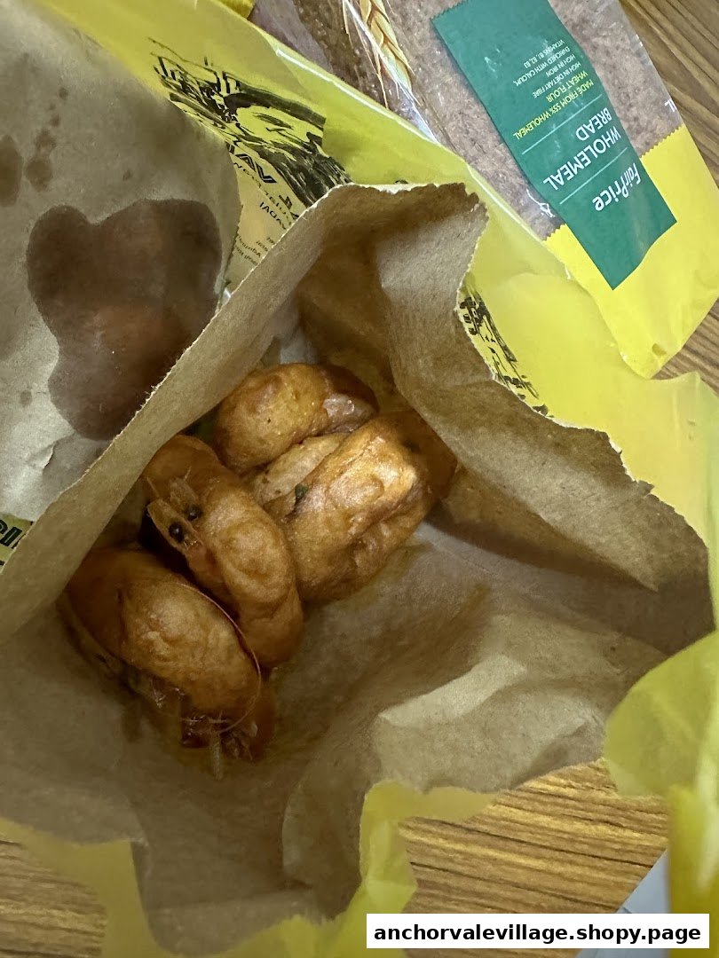 Golden-brown vadai pieces served in a traditional paper bag, ready to enjoy.