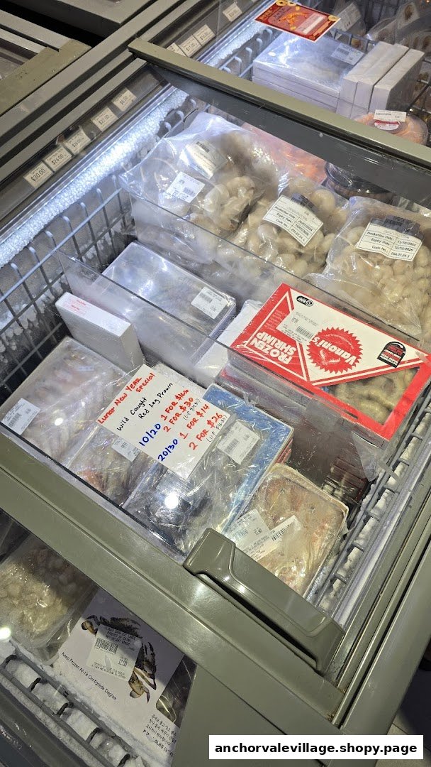 A freezer display showcasing various packaged frozen seafood, including prawns, with visible pricing.