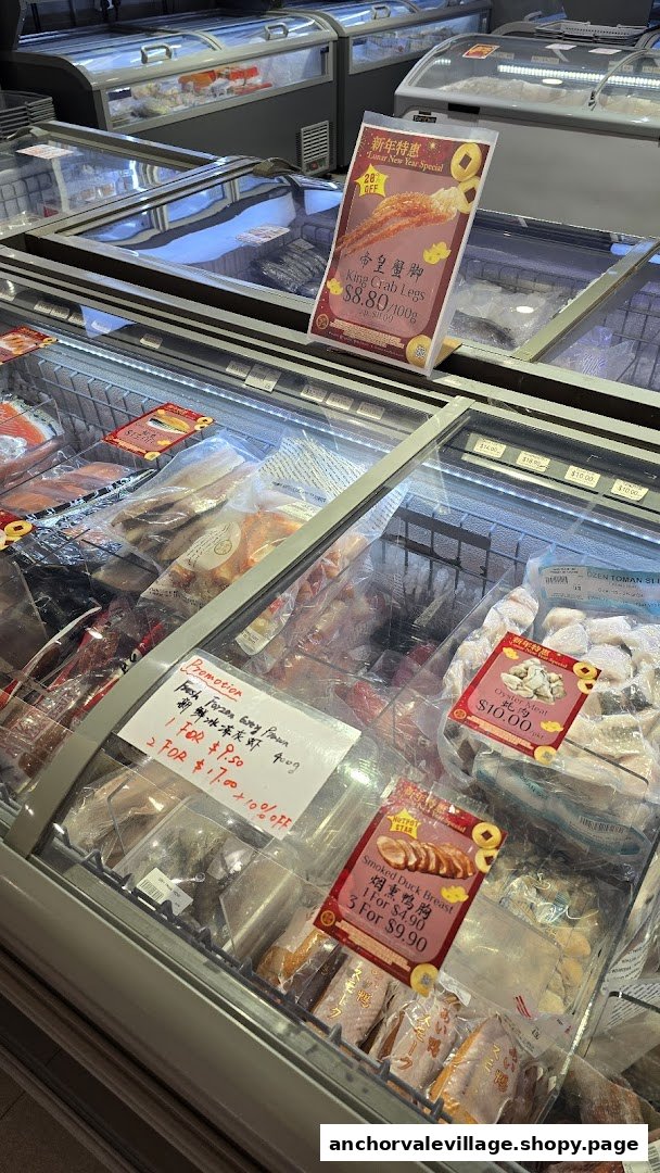 Interior view of a seafood market showcasing various frozen seafood and meat products in display freezers.