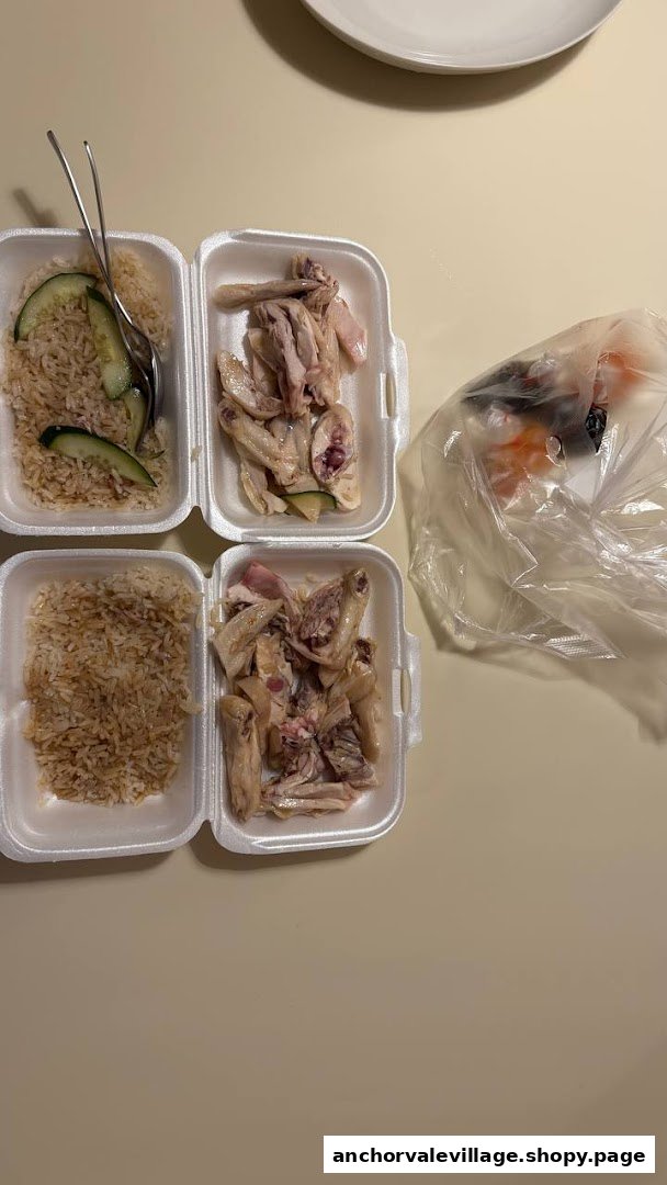 Two servings of chicken rice in takeout containers, featuring steamed chicken and fragrant rice.