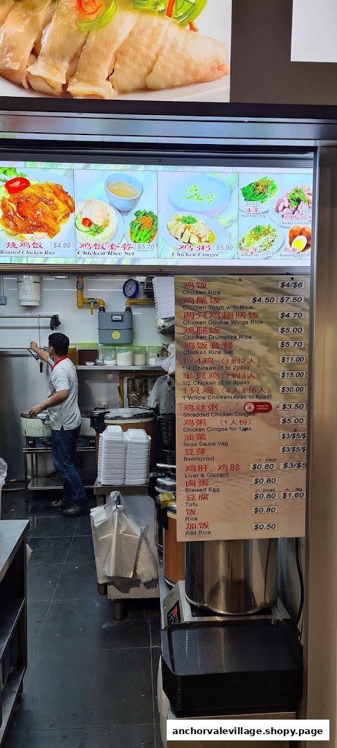 A hawker stall kitchen with a chef preparing food and a detailed menu board displaying chicken rice dishes.
