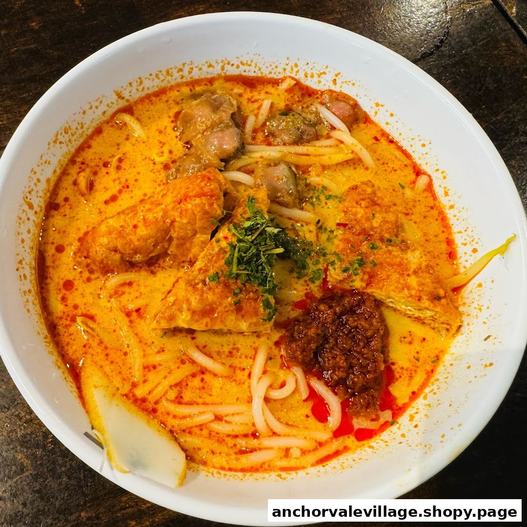 A vibrant bowl of curry noodles with various toppings, showcasing rich colors and textures.