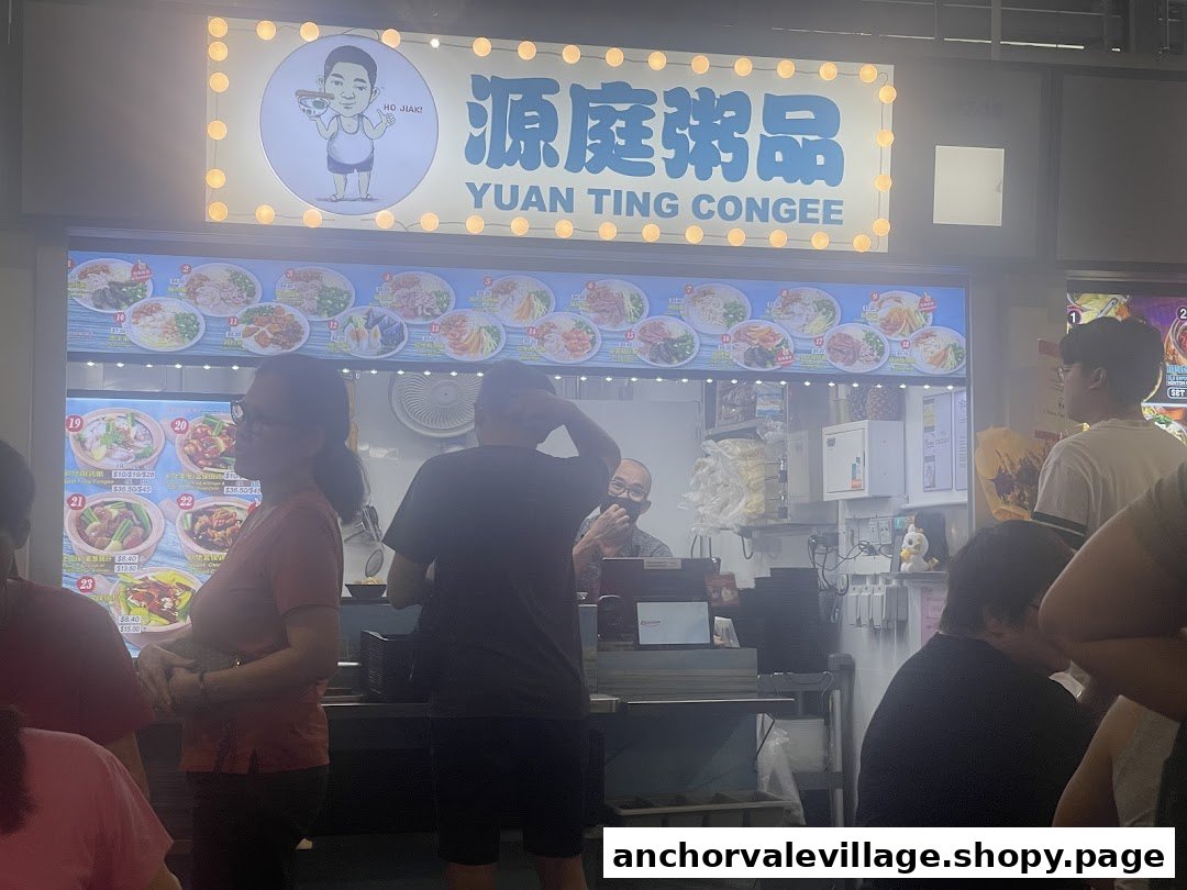 The bustling front of Yuan Ting Congee, featuring its illuminated sign, menu displays, and customers.