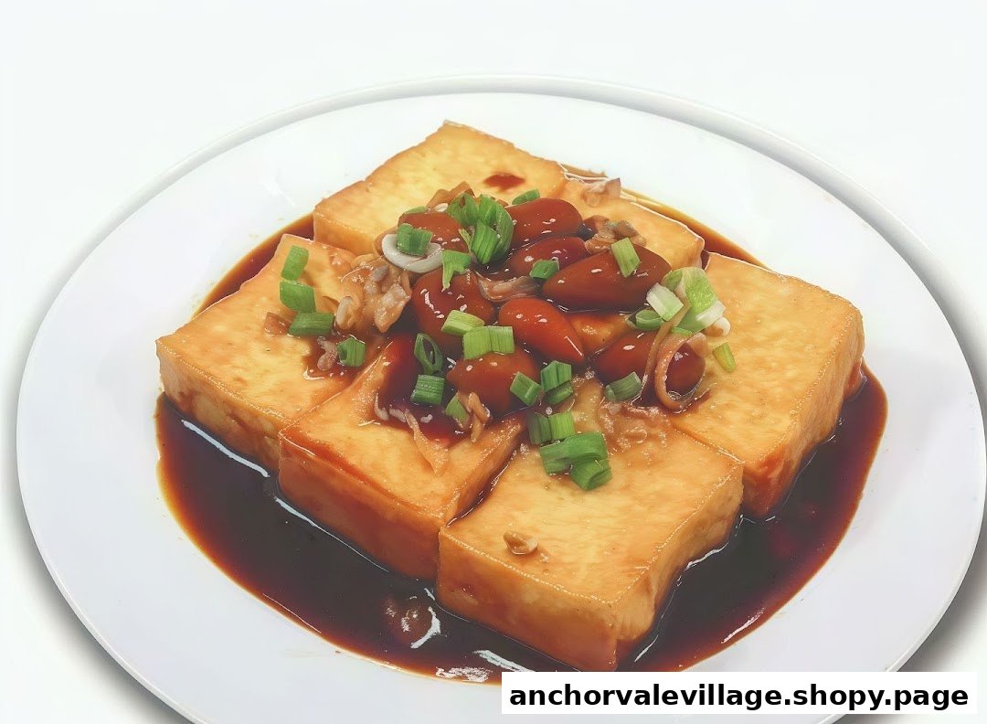 A plate of braised tofu with a savory sauce, topped with scallions and small brown ingredients.
