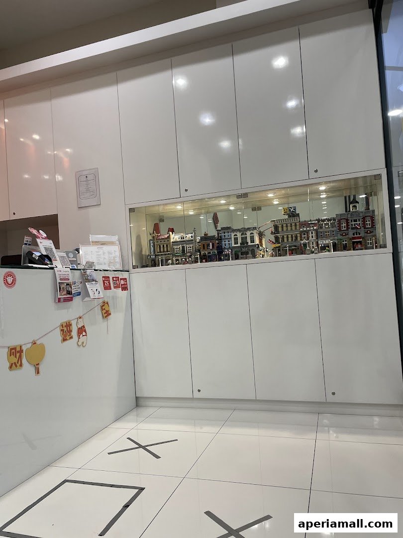 Interior shot of a clean, modern reception area with white cabinets and a display of Lego buildings.
