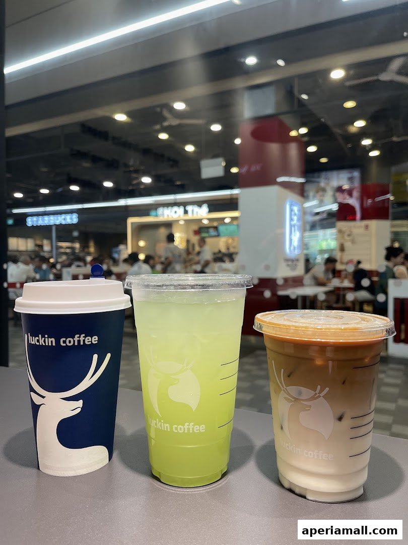 Three Luckin Coffee drinks: a hot coffee, a green iced beverage, and a latte.