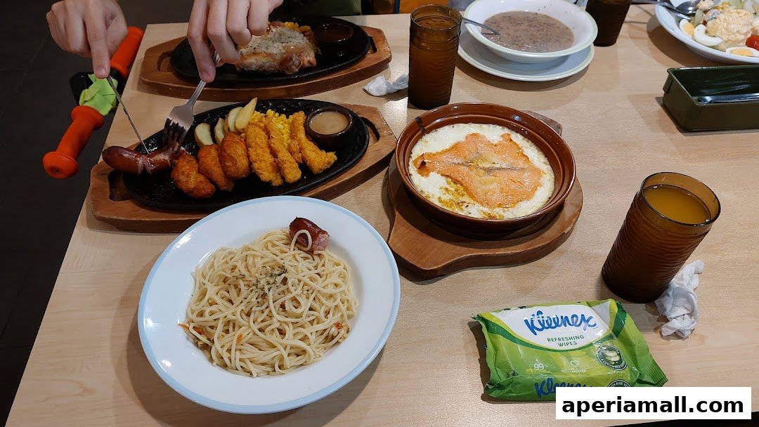 A table laden with various dishes including pasta, grilled meat, fried items, and drinks.