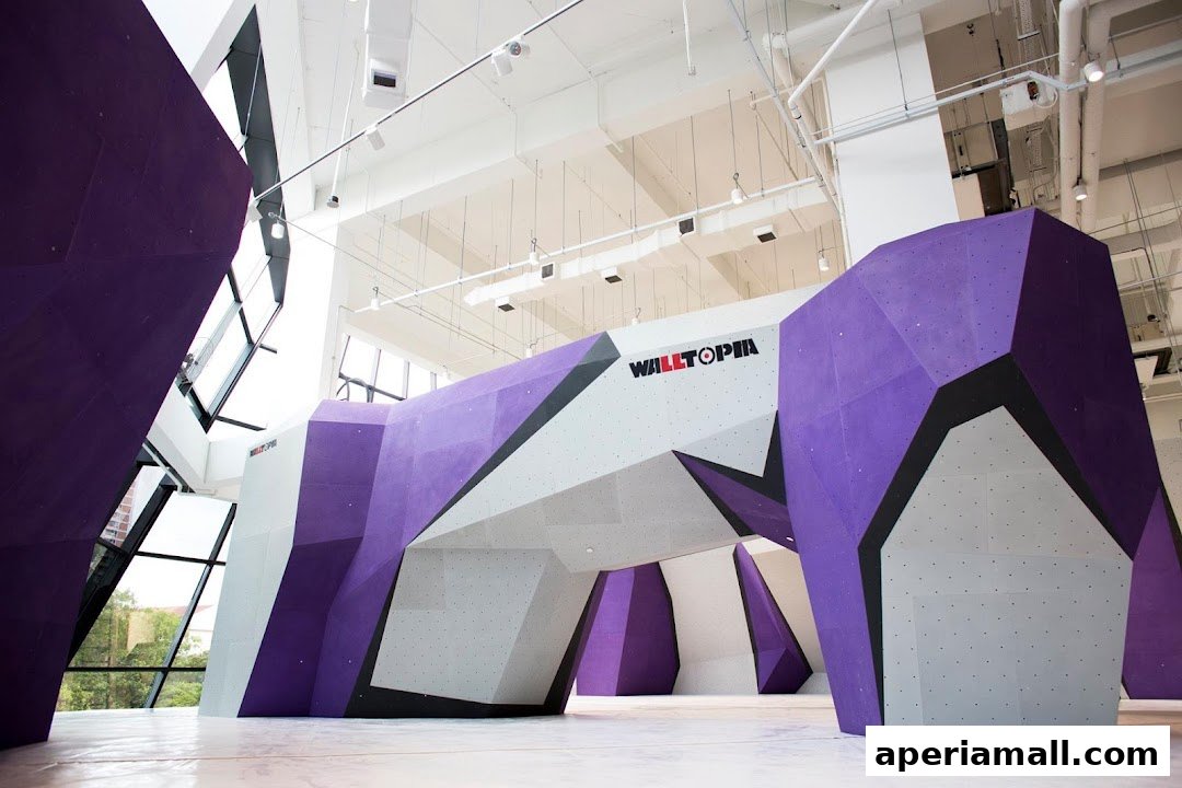Interior view of a modern bouldering gym with purple and grey climbing walls.