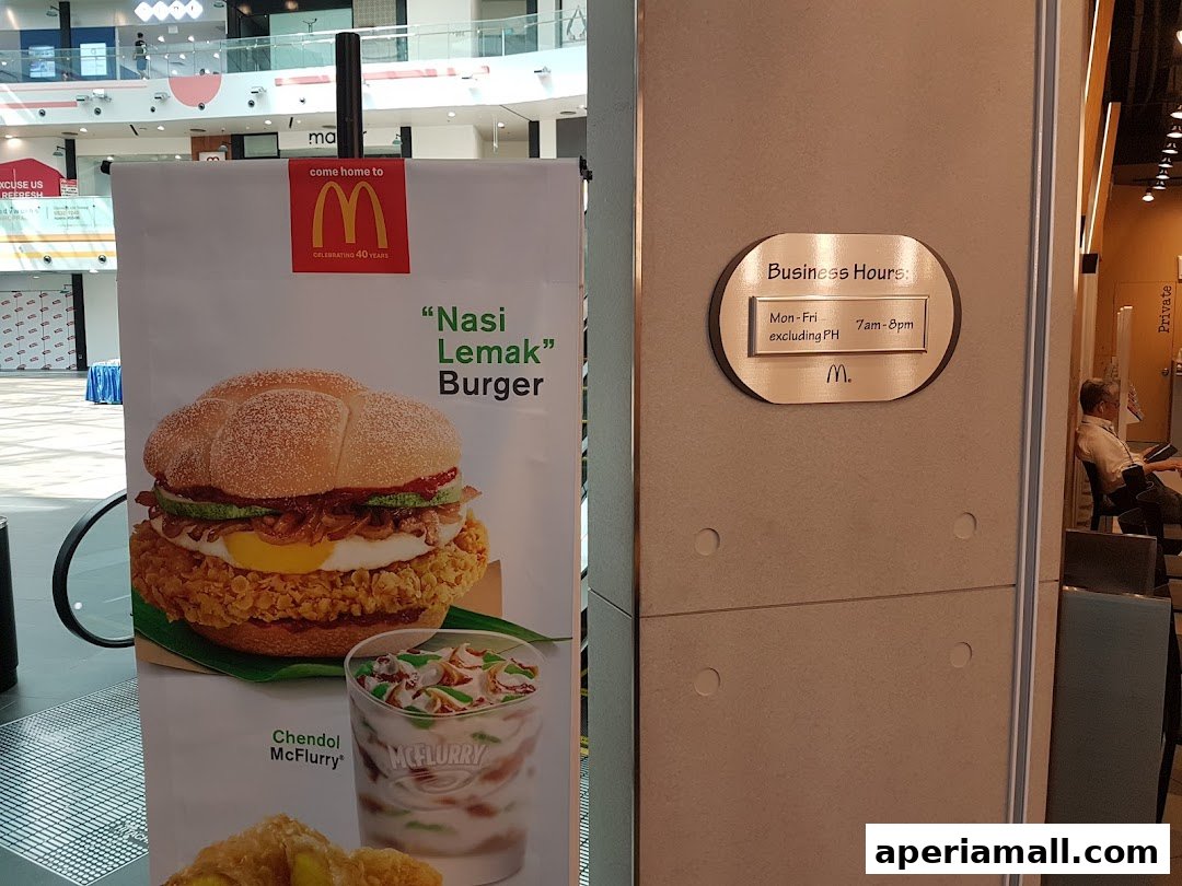 McDonald's advertisement featuring a Nasi Lemak Burger and Chendol McFlurry, with business hours displayed.