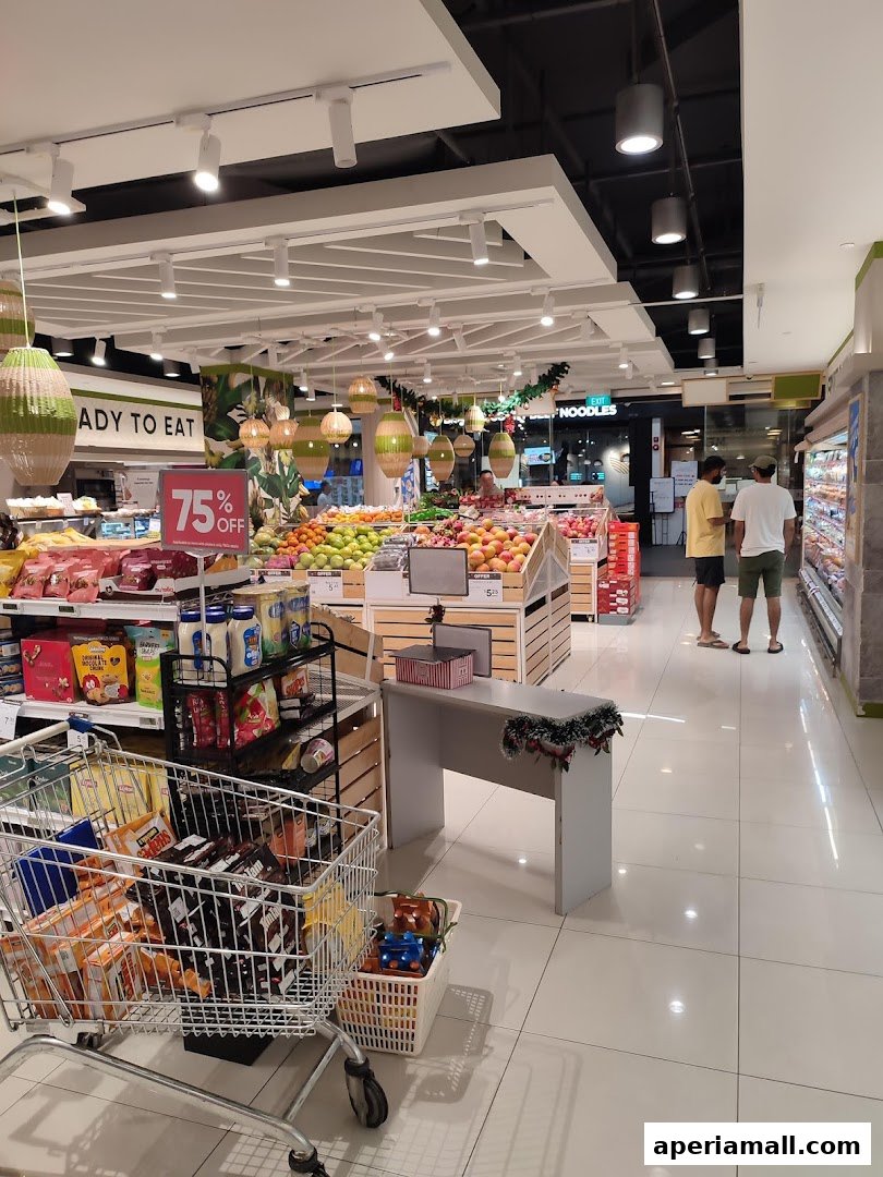 Interior view of a well-stocked supermarket with fresh produce and shopping carts.